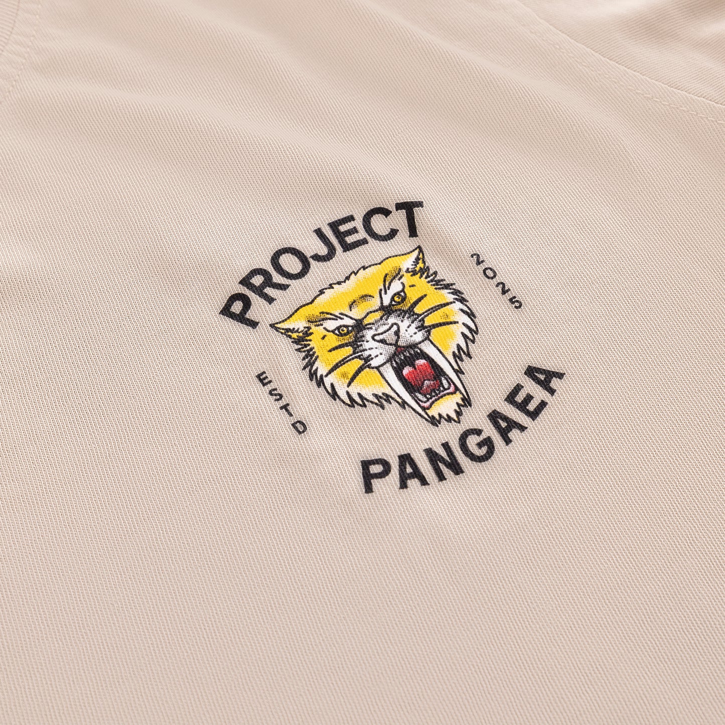 zoomed in front of of tan 100% cotton shirt Sabertooth Tiger face with "est 2025" on sides and "Project Pangaea" written above and below in black- image in top left corner of shirt. 

heavy weight, high quality stylish sabertooth t-shirt. 
Smilodon t shirt, ice age t-shirt 
prehistoric t-shirt