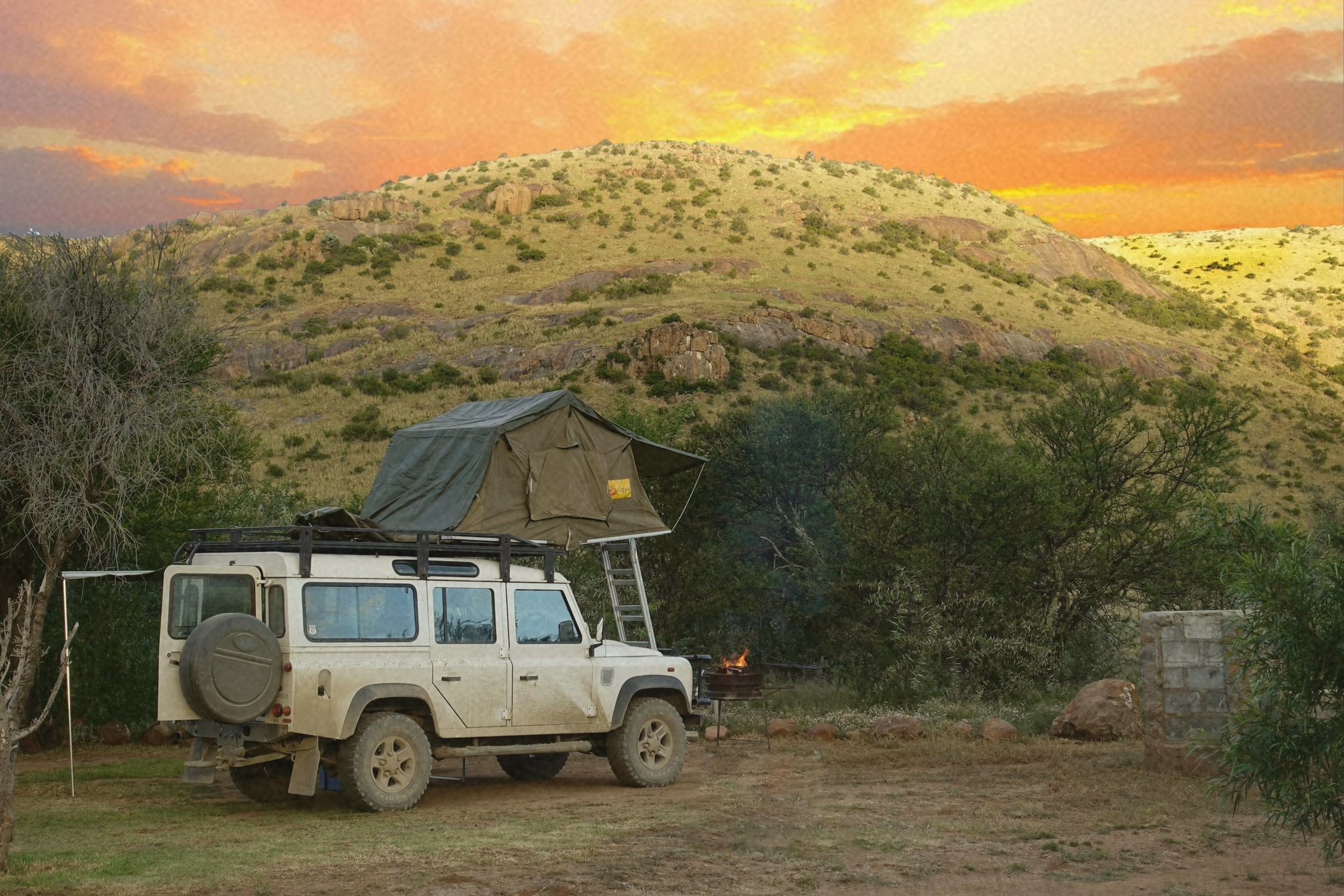 person camping and exploring in a jeep with a rooftop tent to show the modern explorer out in nature
